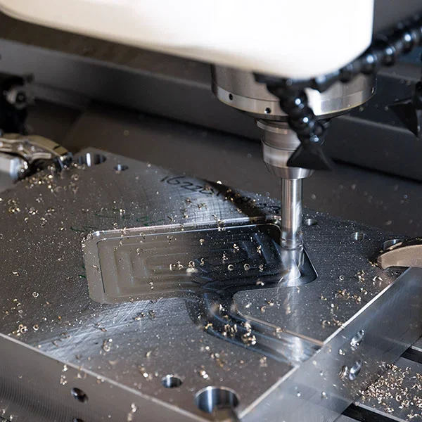 With a CNC machine, a cavity is milled into a block of steel.