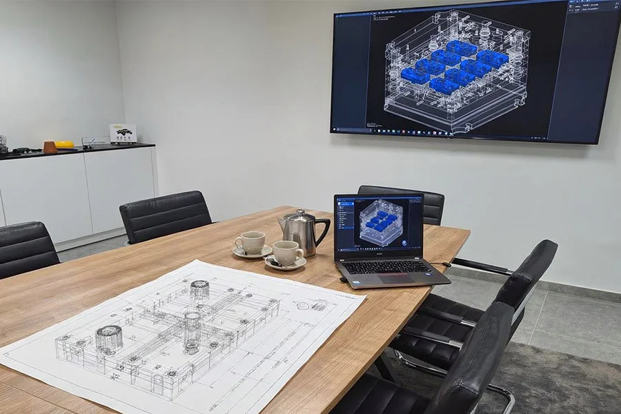 Engineering: during a meeting, the team discusses the plans for a new mould project